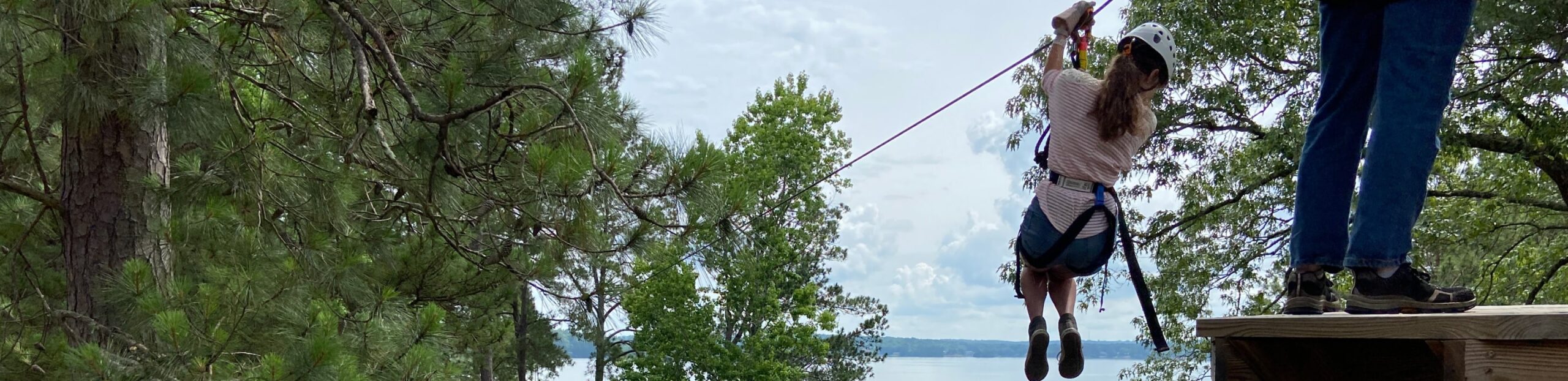 Woman ziplining in Wind Creek State Park